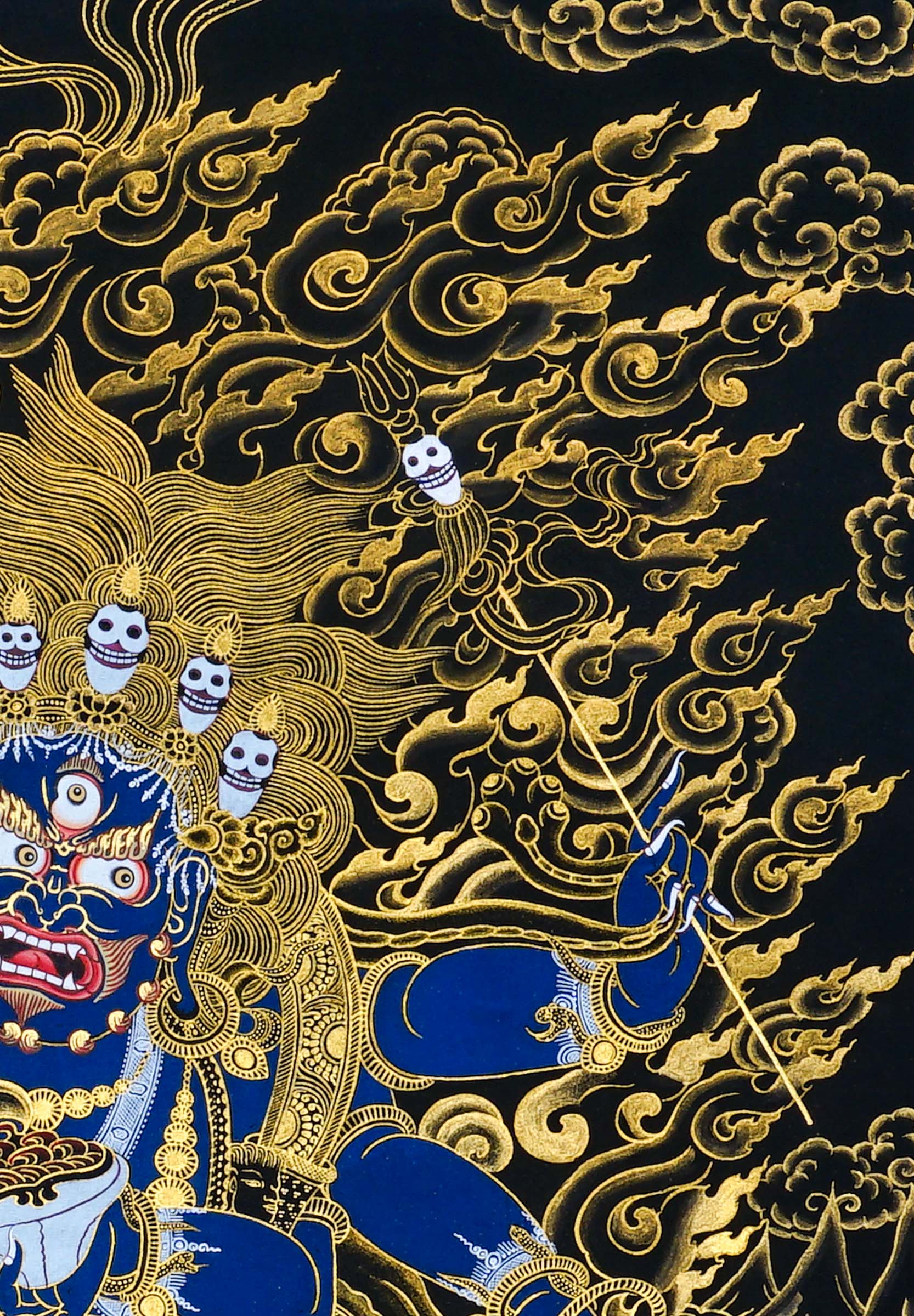 Close-up detail of Six Hand Mahakala Thangka Painting, six-armed wrathful protector in black, gold and blue with flame motifs and lotus base