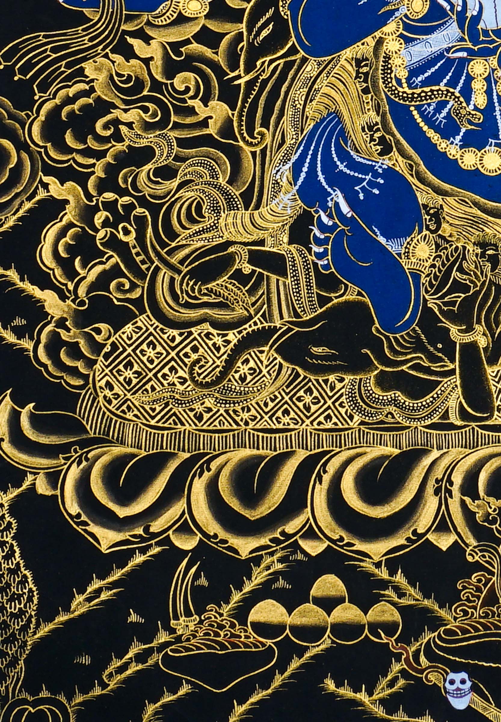 Close-up detail of Six Hand Mahakala Thangka Painting, six-armed wrathful protector in black, gold and blue with flame motifs and lotus base