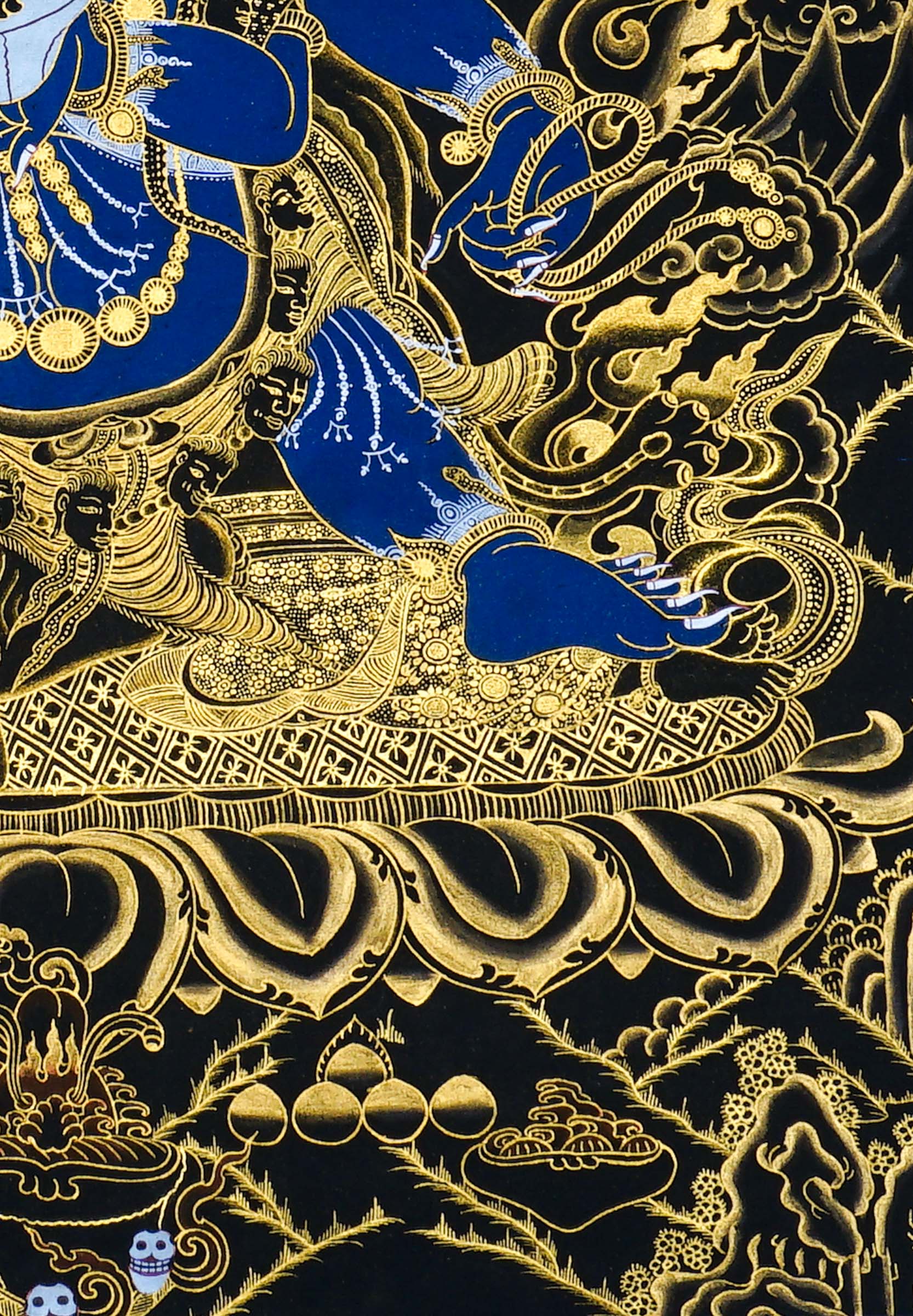 Close-up detail of Six Hand Mahakala Thangka Painting, six-armed wrathful protector in black, gold and blue with flame motifs and lotus base