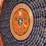 Tibetan mantra mandala artwork with sacred script and decorative floral borders