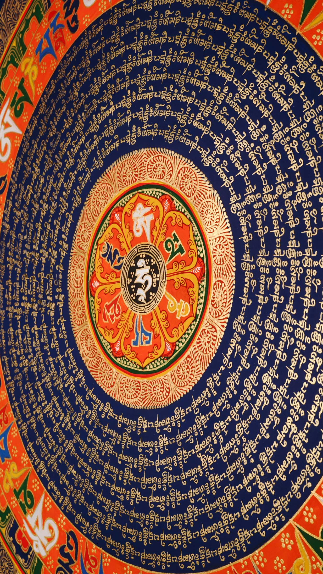 Tibetan mantra mandala artwork with sacred script and decorative floral borders