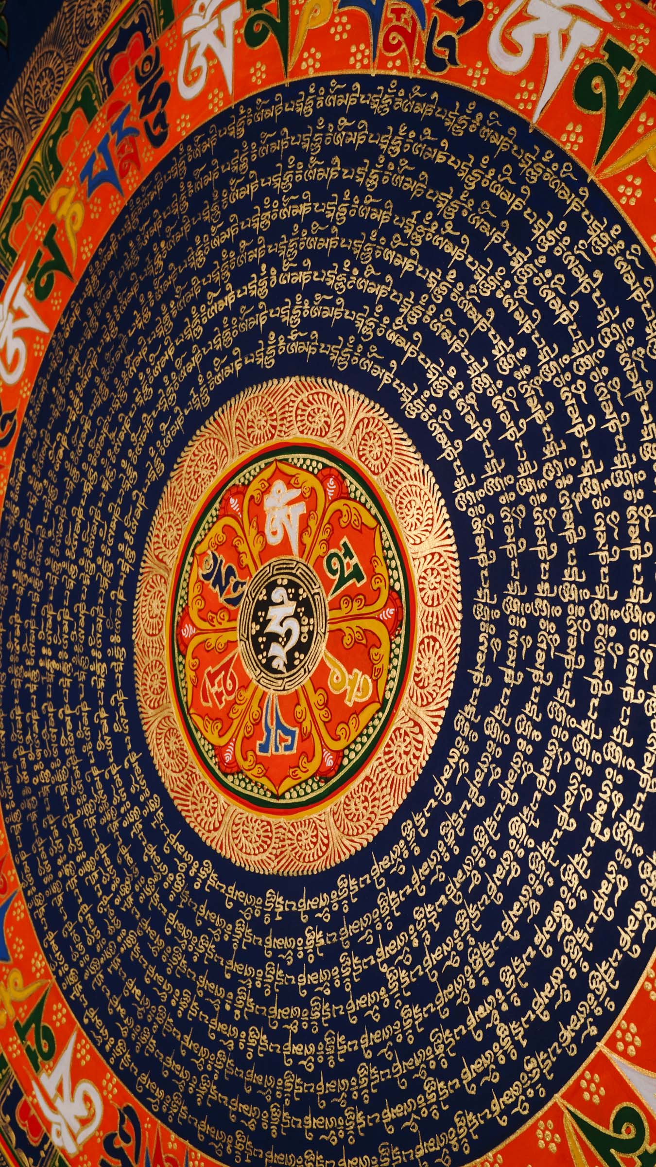 Tibetan mantra mandala artwork with sacred script and decorative floral borders