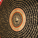 Tibetan mantra mandala artwork with gold script on black background