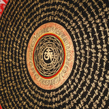Tibetan mantra mandala artwork with gold script on black background