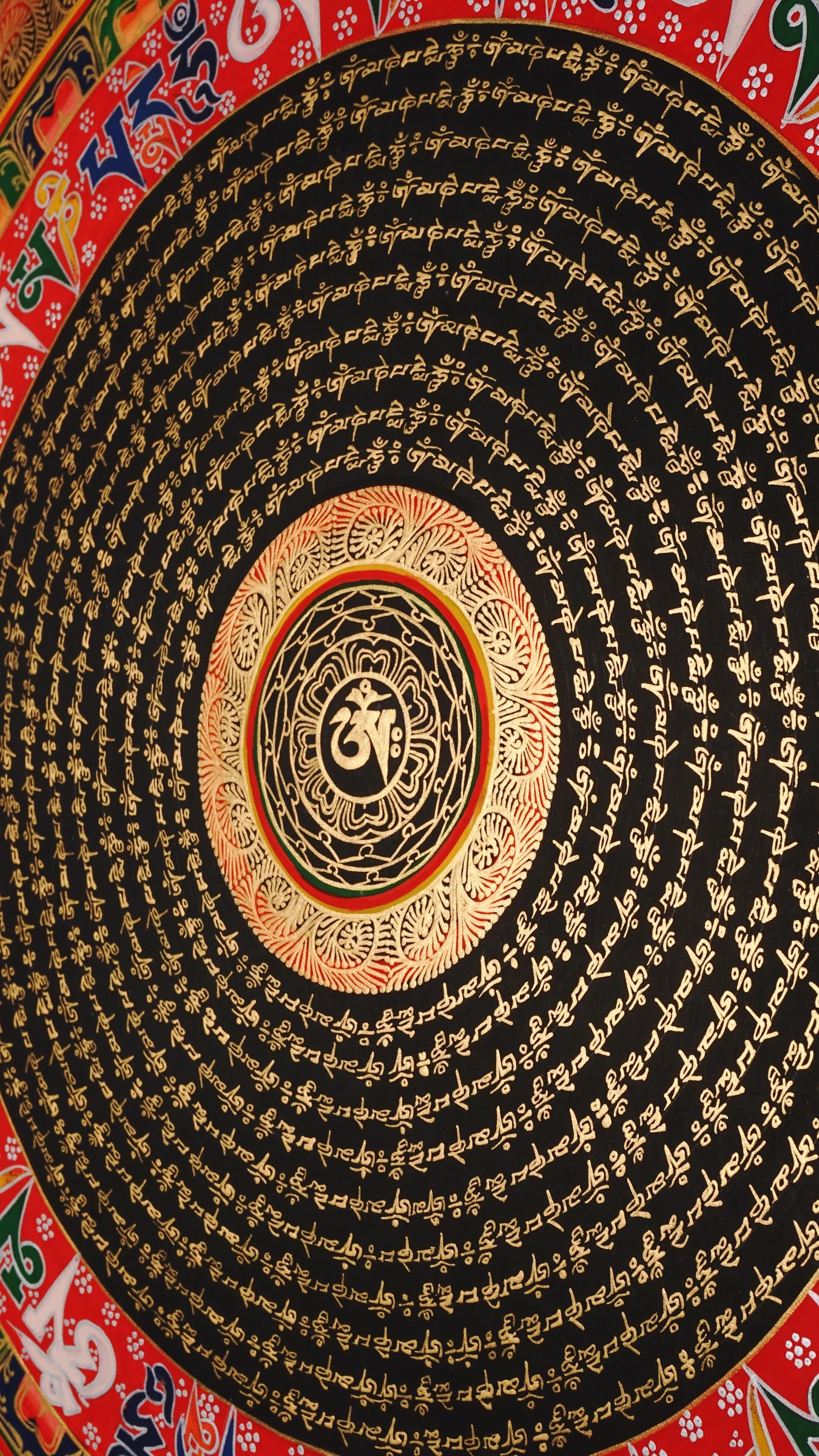 Tibetan mantra mandala artwork with gold script on black background