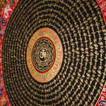 Tibetan mantra mandala artwork with gold script on black background