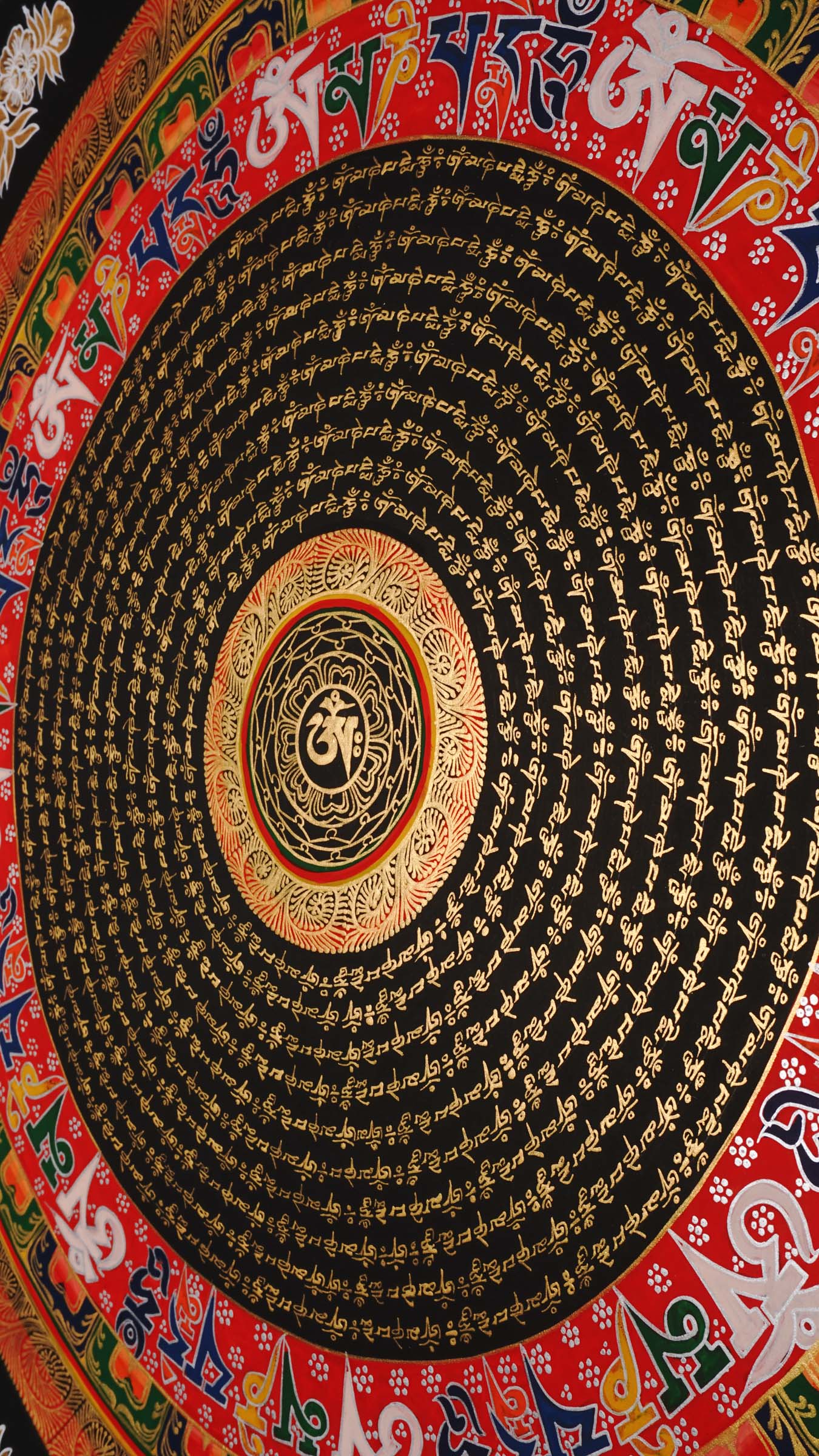Tibetan mantra mandala artwork with gold script on black background
