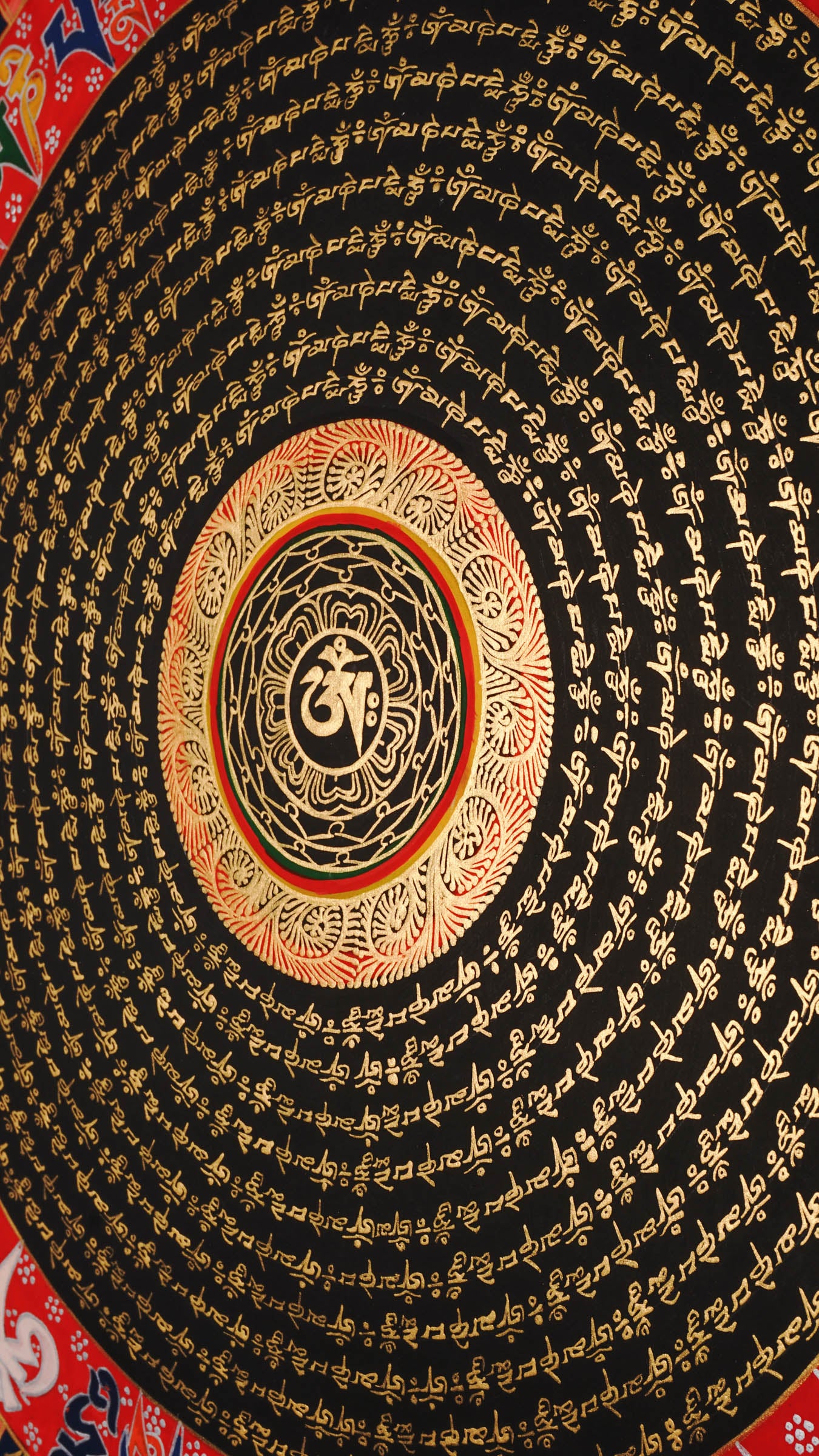 Tibetan mantra mandala artwork with gold script on black background