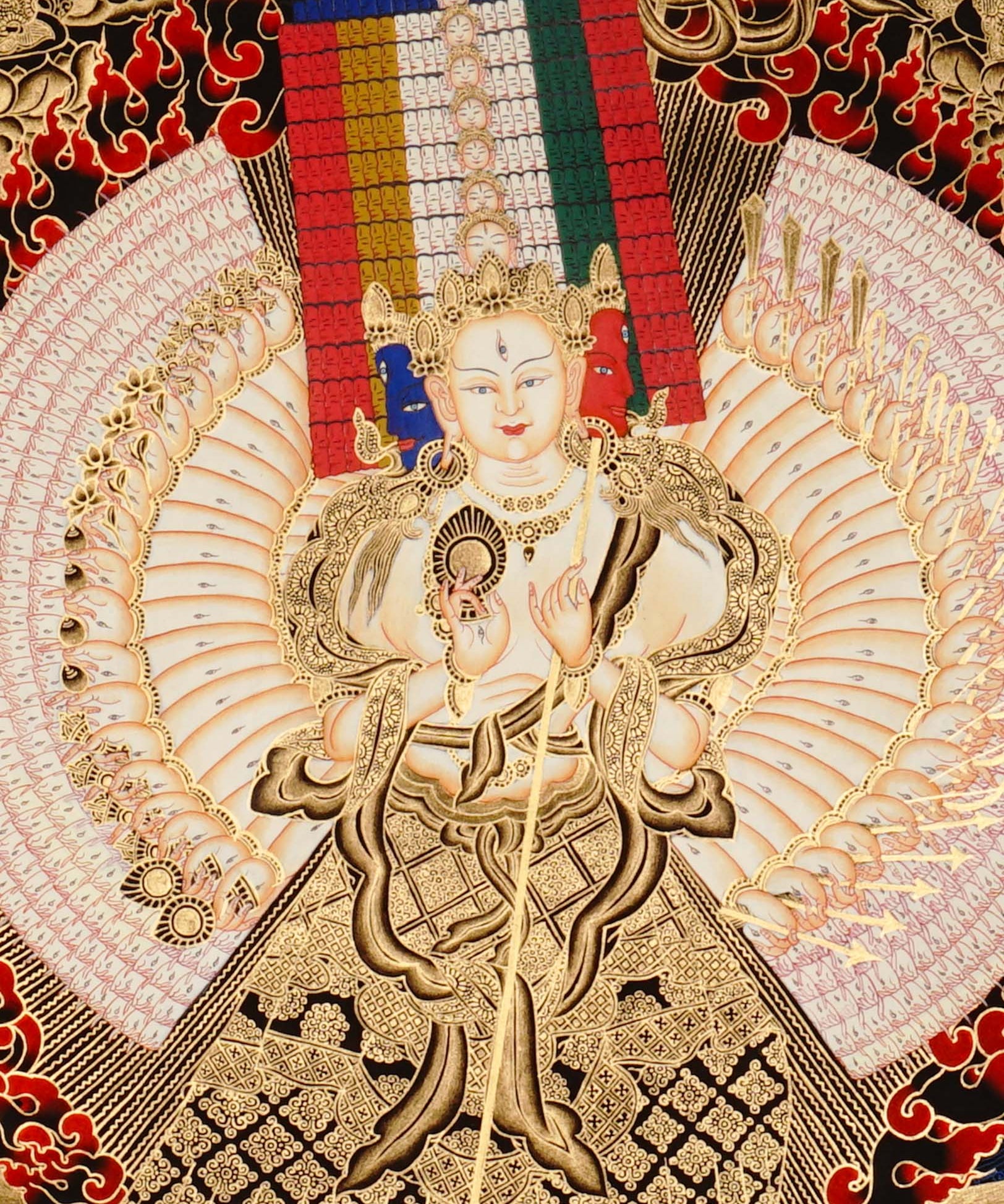 Dukkar thangka painting featuring the White Umbrella Goddess Sitatapatra with many arms, sacred implements, flame aura, gold-tone details