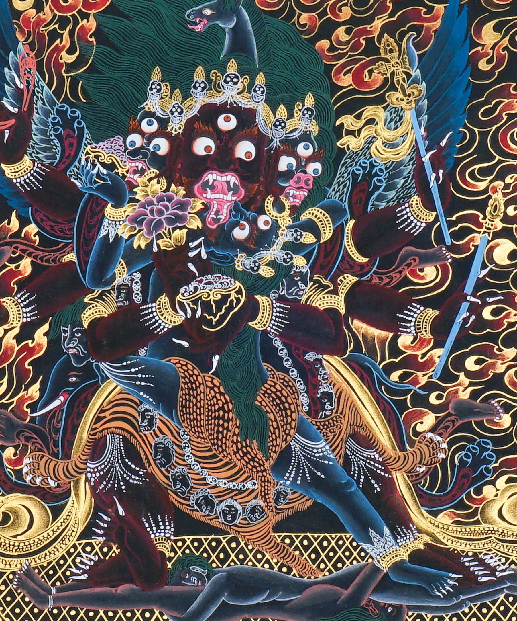 Close-up detail of Vajrakilaya Thangka Painting, wrathful Vajrakilaya in black and gold with multiple arms, skull crown and lotus base