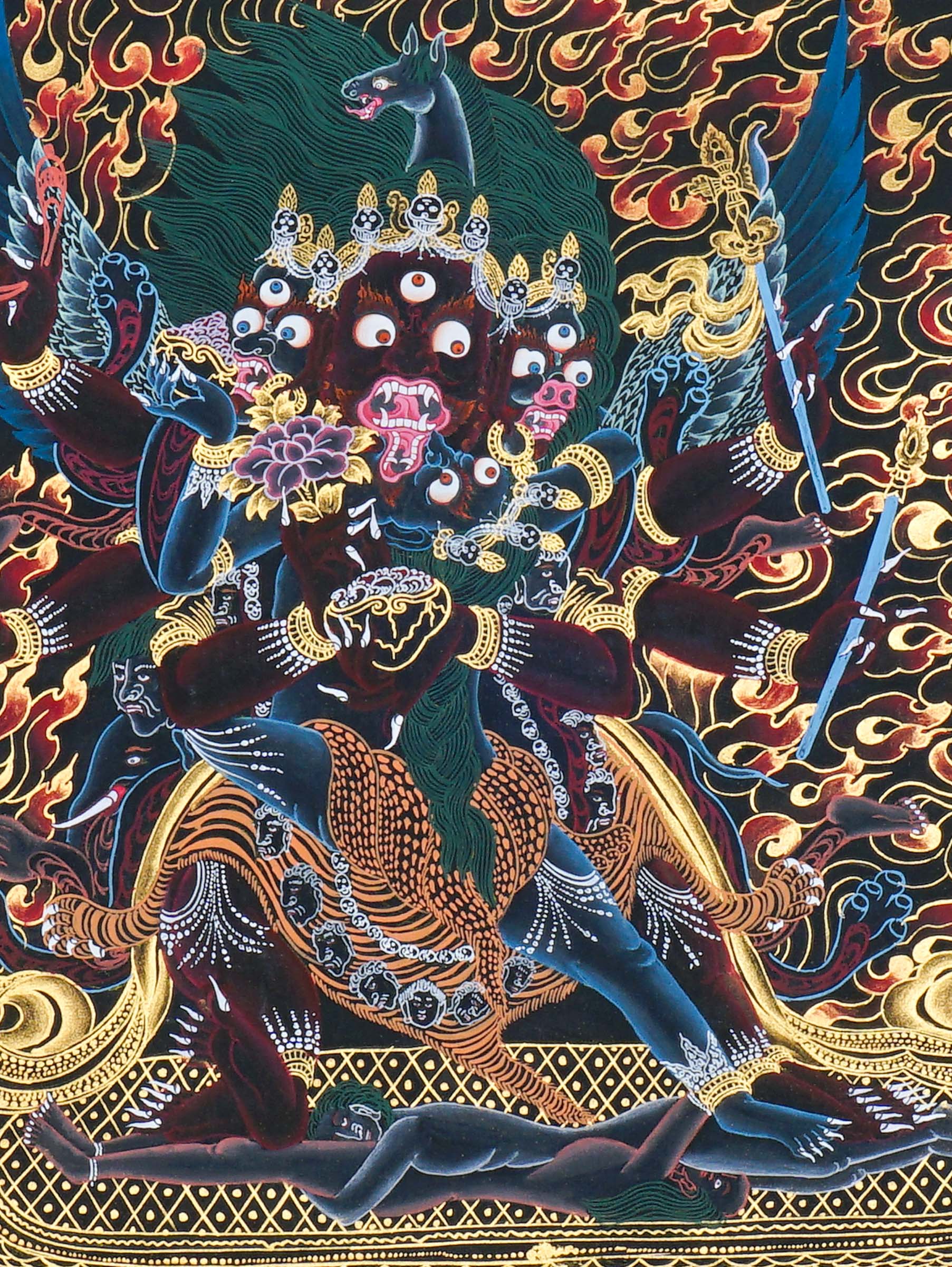 Close-up detail of Vajrakilaya Thangka Painting, wrathful Vajrakilaya in black and gold with multiple arms, skull crown and lotus base