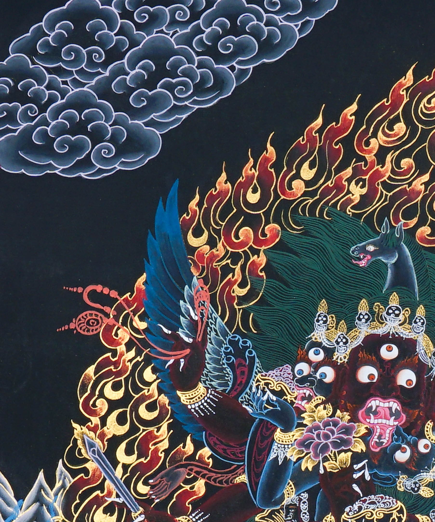 Close-up detail of Vajrakilaya Thangka Painting, wrathful Vajrakilaya in black and gold with multiple arms, skull crown and lotus base