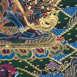 Close-up detail of Vajrakilaya Thangka Painting, wrathful Vajrakilaya in black and gold with multiple arms, skull crown and lotus base