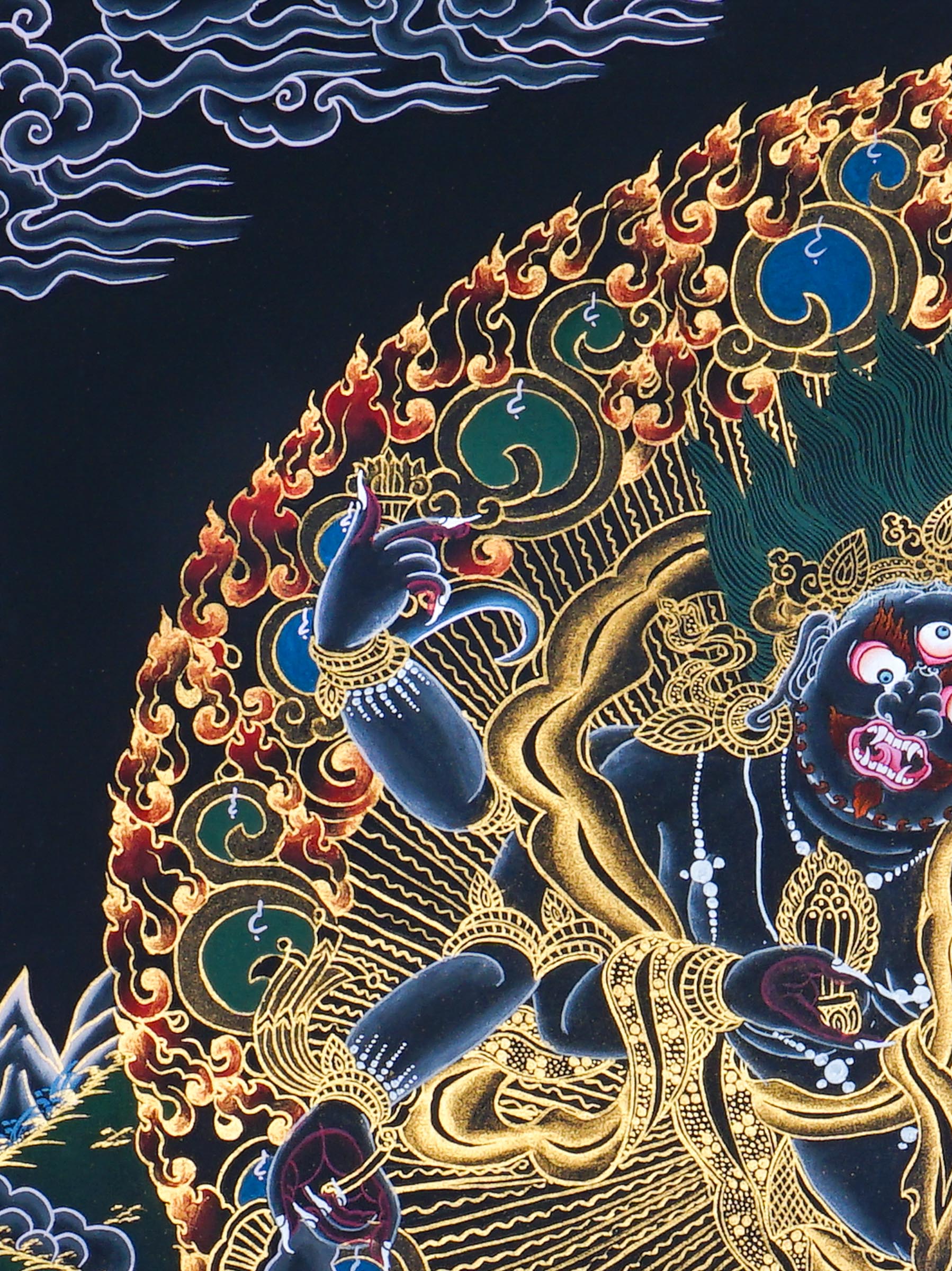 Six Hand Mahakala Thangka Painting showing a wrathful Tibetan Buddhist protector deity with six arms, flame aura, ritual implements, offering symbols, lotus base and Himalayan landscape in black, gold, blue and red tones.