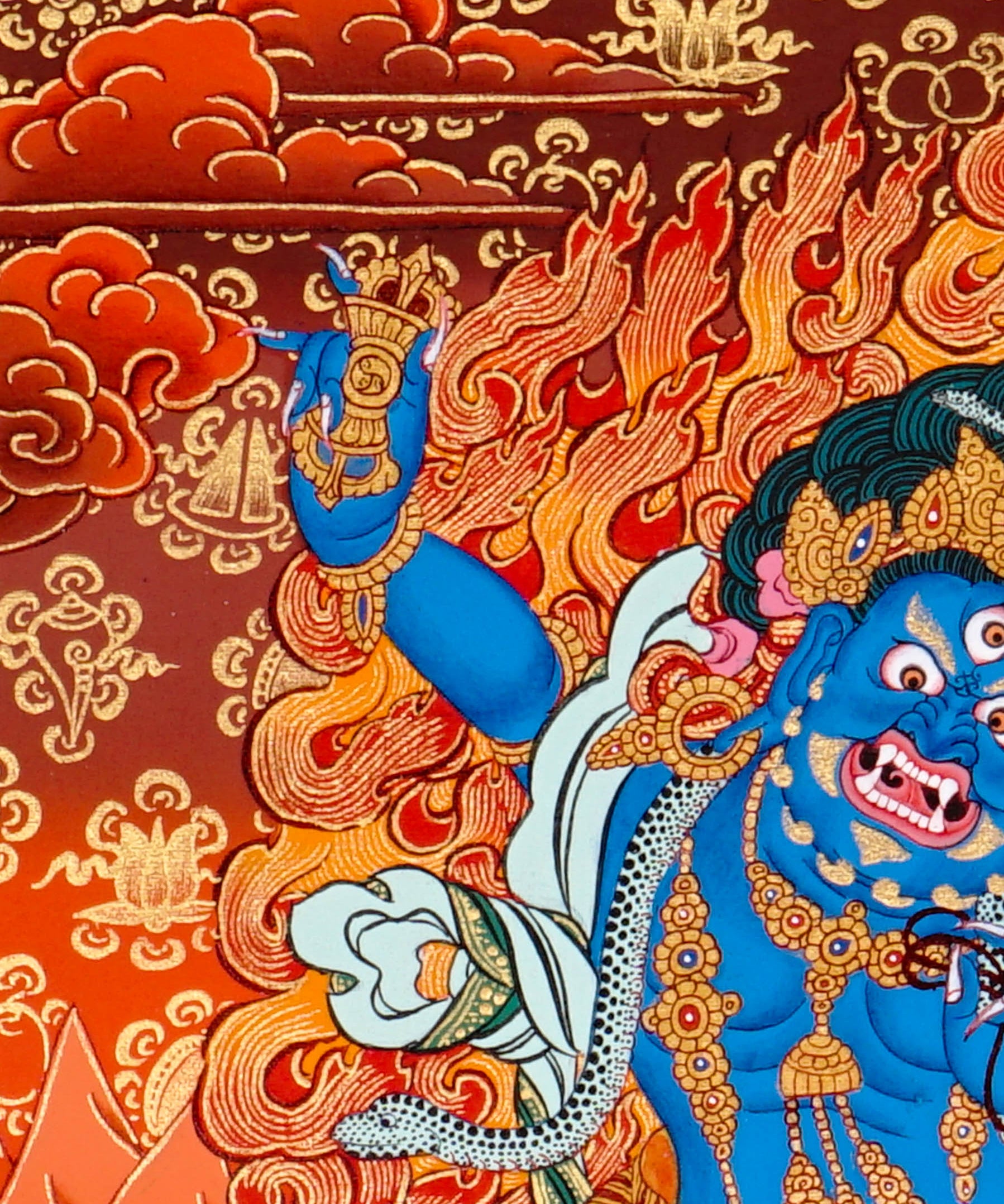Vajrapani thangka painting showing a blue wrathful Tibetan Buddhist protector deity holding a raised vajra, surrounded by flames and seated on a lotus throne against a vivid orange-red background.