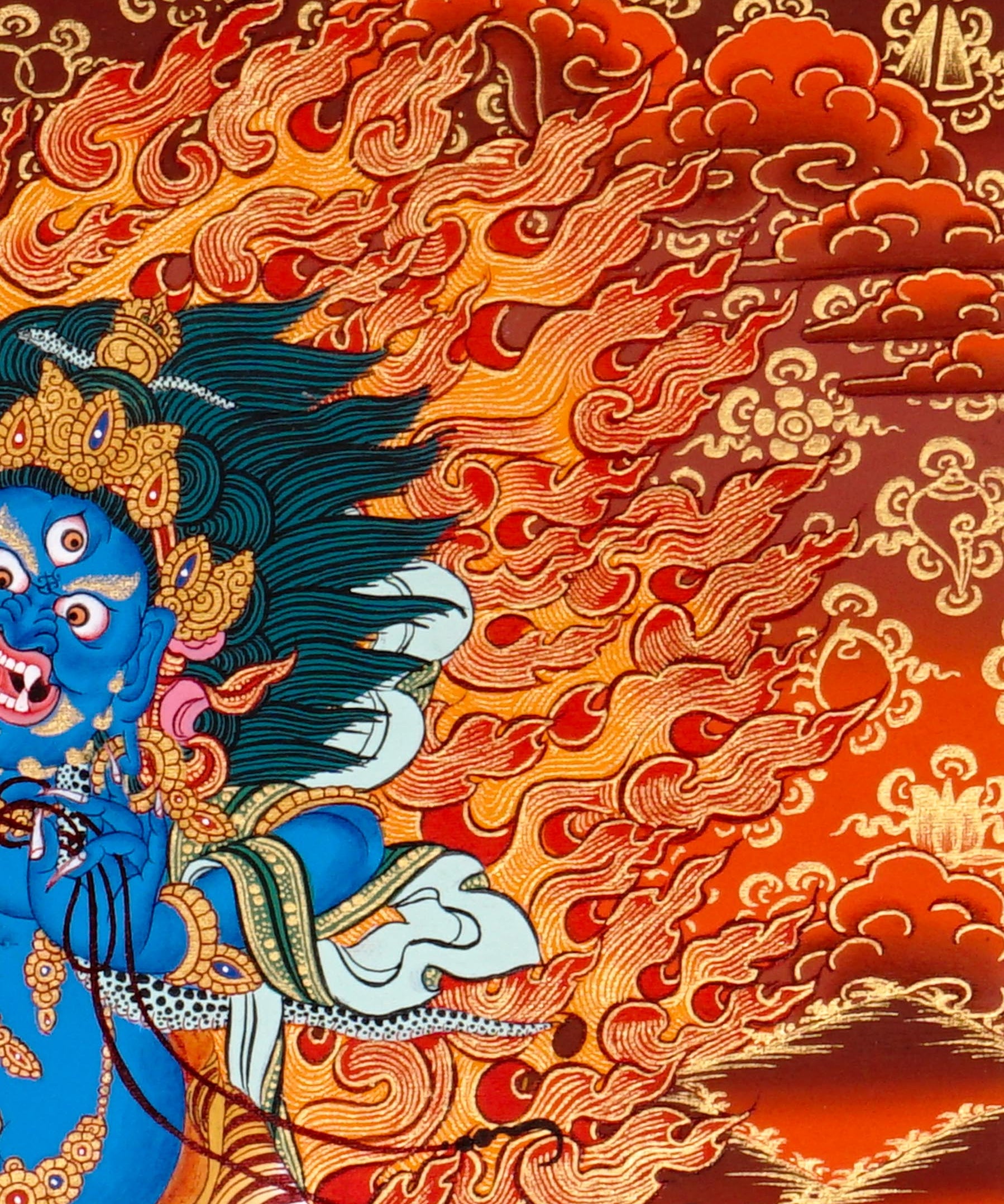 Vajrapani thangka painting showing a blue wrathful Tibetan Buddhist protector deity holding a raised vajra, surrounded by flames and seated on a lotus throne against a vivid orange-red background.