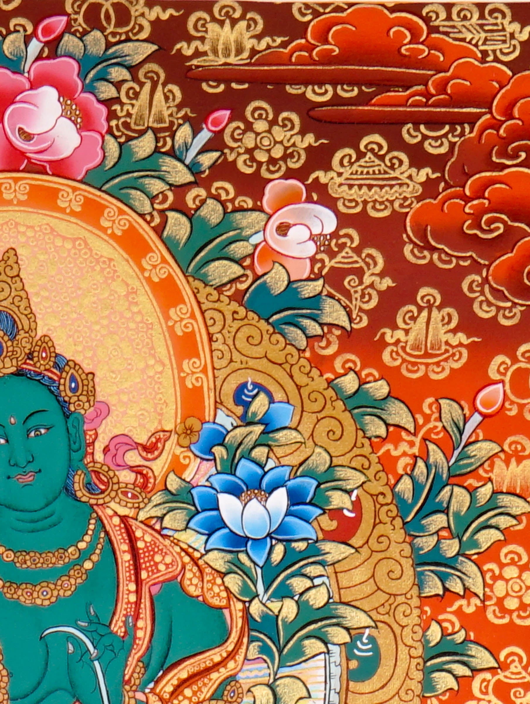Green Tara Thangka Painting showing the Tibetan Buddhist goddess seated on a pink lotus throne with one leg extended, holding a lotus flower, surrounded by a radiant halo, sacred ornaments and red-gold background.
