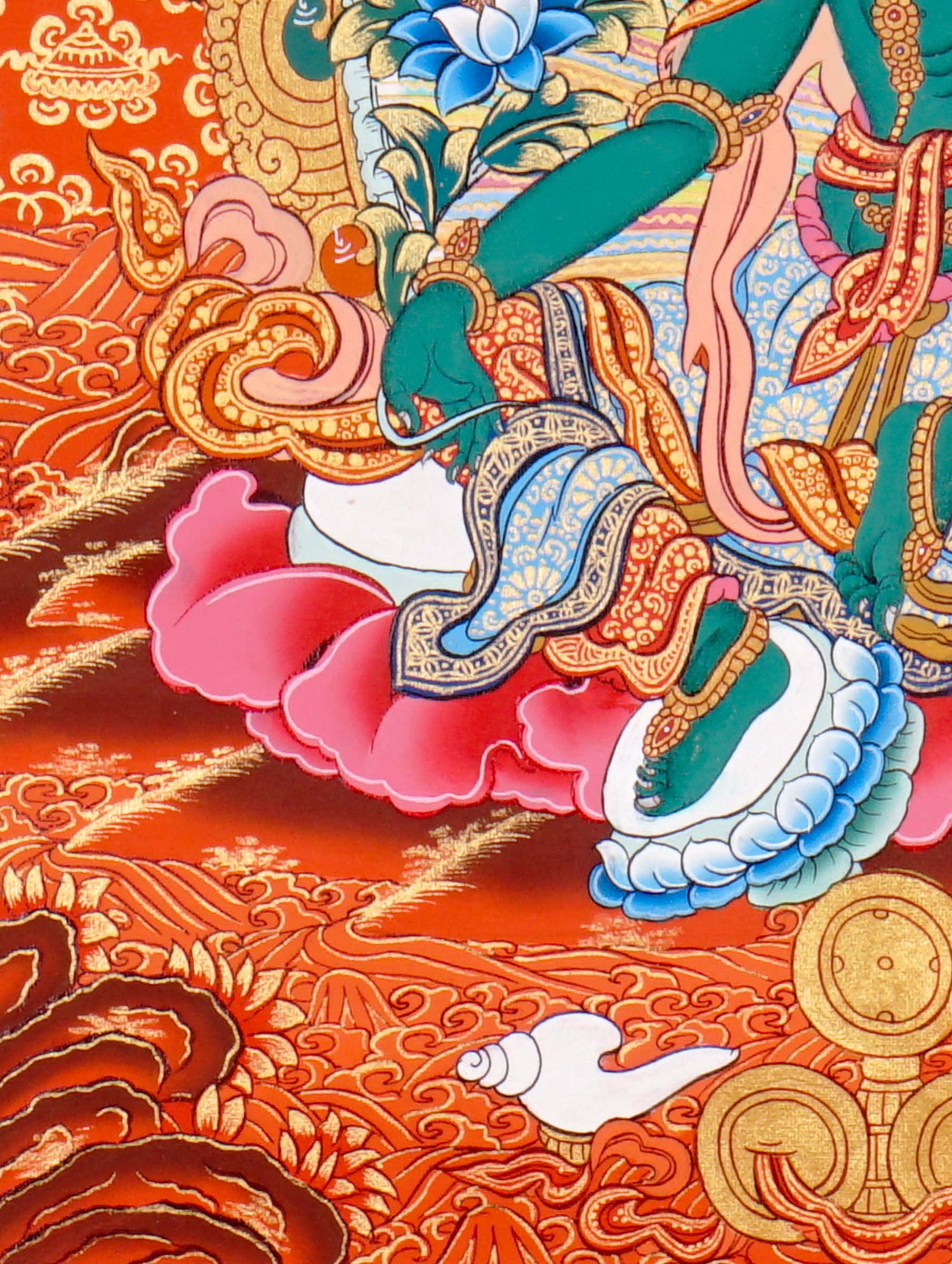 Green Tara Thangka Painting showing the Tibetan Buddhist goddess seated on a pink lotus throne with one leg extended, holding a lotus flower, surrounded by a radiant halo, sacred ornaments and red-gold background.