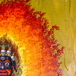 Mahakala Oil Painting showing a wrathful Tibetan Buddhist Dharma protector with black face, skull crown, curved knife, skull cup, flame aura, lotus base, offering symbols and golden textured background.