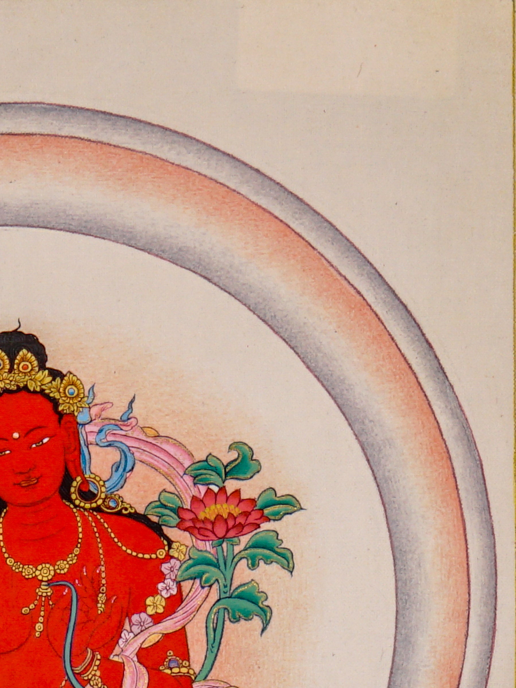 Red Tara thangka painting featuring Tara seated on a pink lotus throne with a lotus flower, radiant halo, ornaments