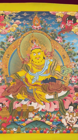 Yellow Zambhala thangka with Tibetan Buddhist wealth deity seated on lotus seat
