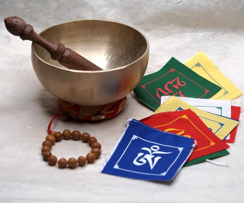 Himalayan singing bowl, prayer flag and bodhi seed bracelets for deep meditation, a perfect spiritual gift for father's day celebration.