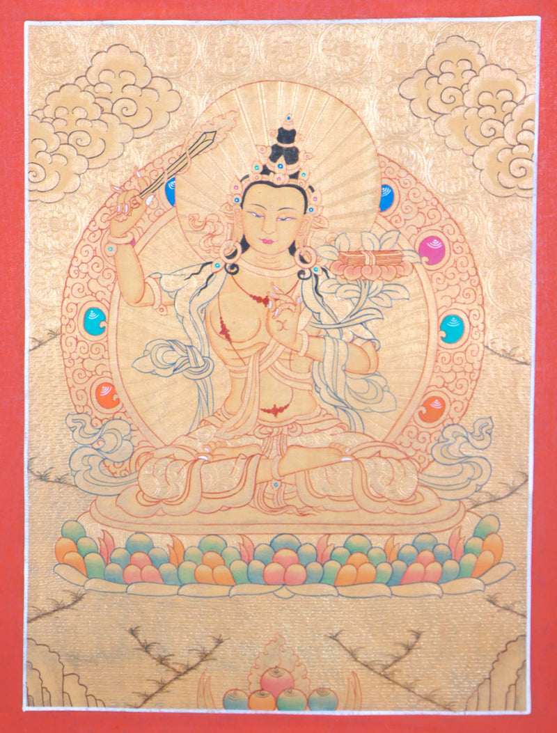 Buddhist Thangka are used as support for one's meditation practice. Manjushri is the Bodhisattva of transcendent wisdom. With the double-edged sword on his right hand he cuts through the illusion and with his left hand holds a lotus with book of Prajna Paramita.