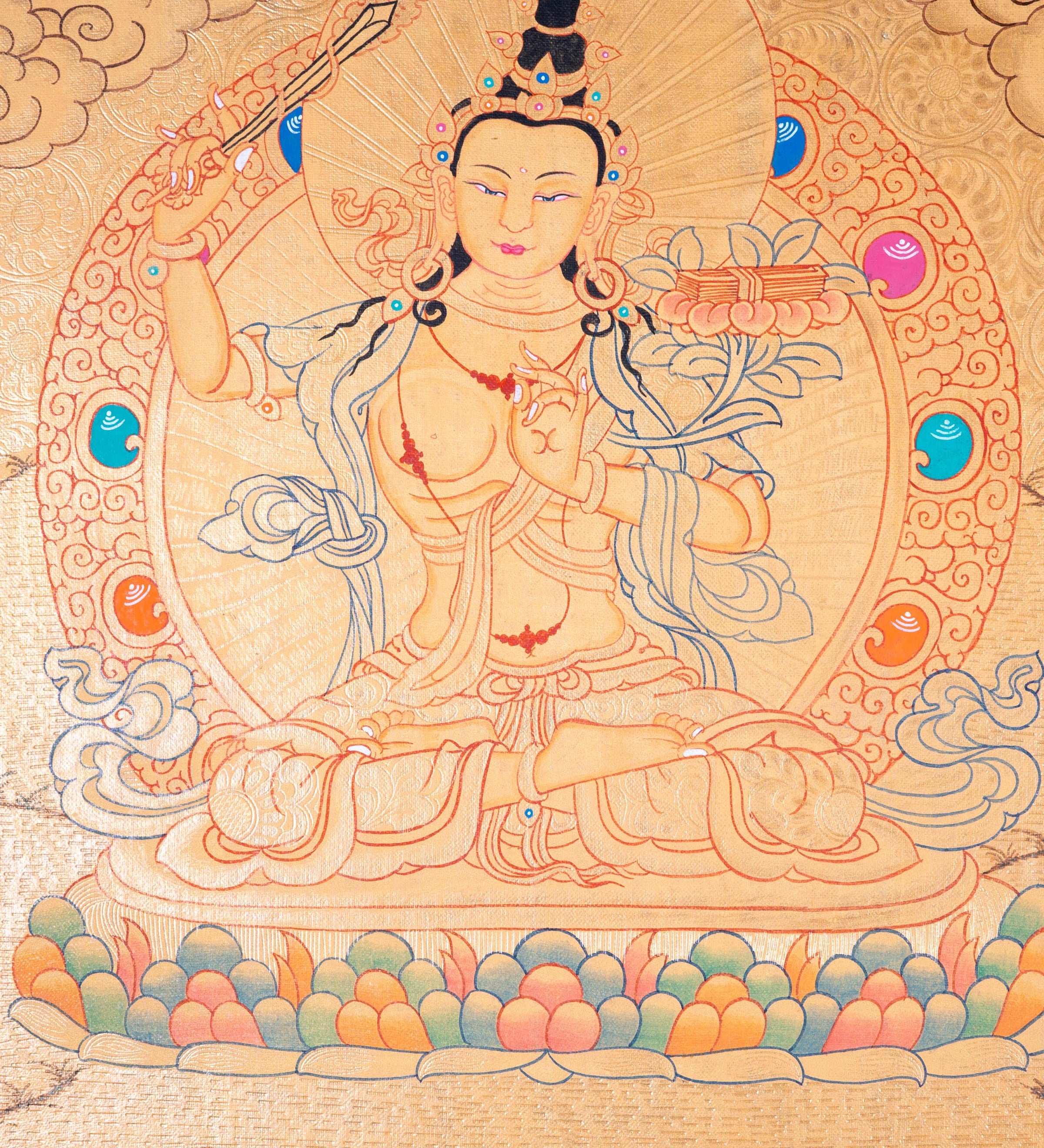 Buddhist Thangka are used as support for one's meditation practice. Manjushri is the Bodhisattva of transcendent wisdom. With the double-edged sword on his right hand he cuts through the illusion and with his left hand holds a lotus with book of Prajna Paramita.