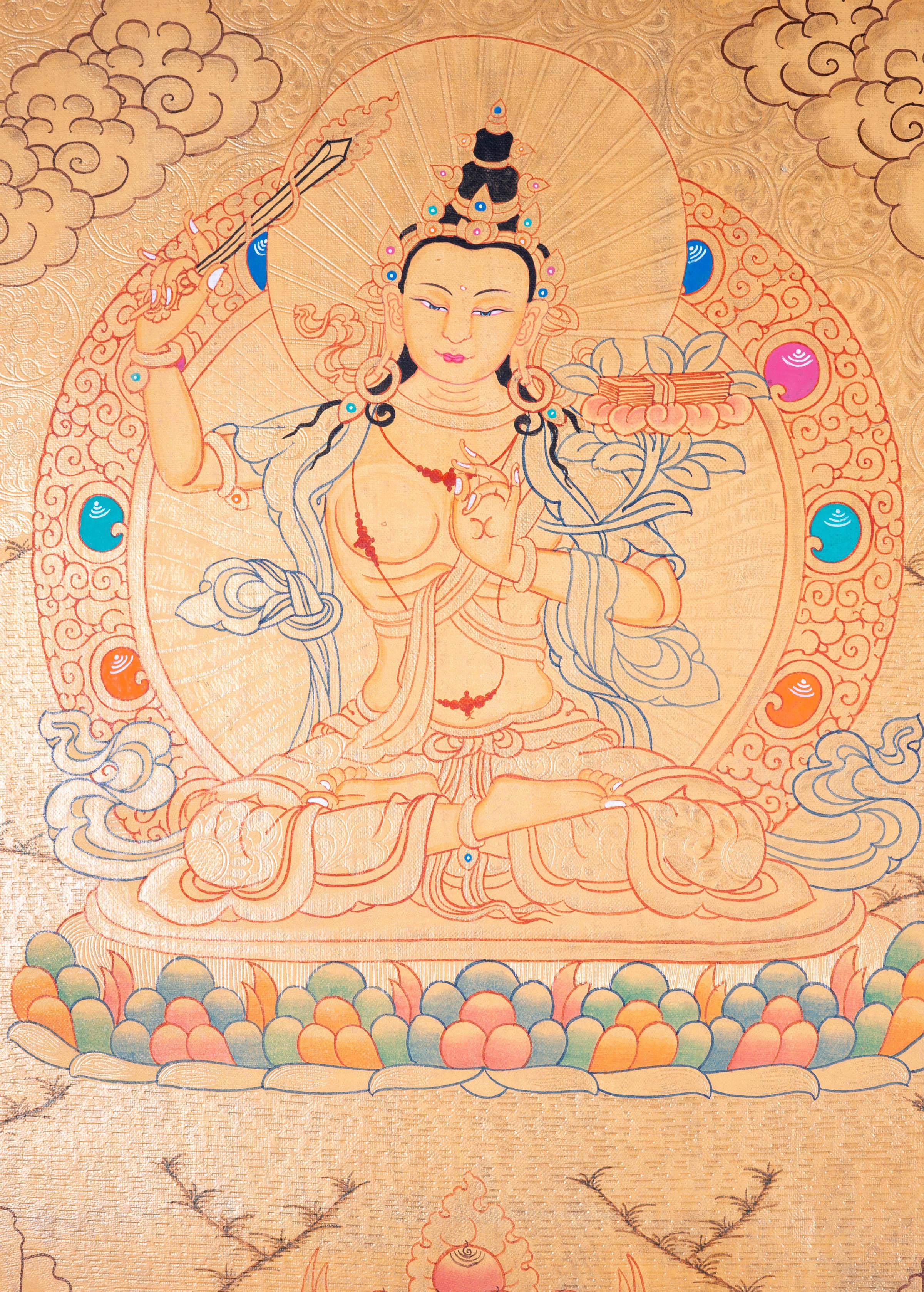 Buddhist Thangka are used as support for one's meditation practice. Manjushri is the Bodhisattva of transcendent wisdom. With the double-edged sword on his right hand he cuts through the illusion and with his left hand holds a lotus with book of Prajna Paramita.