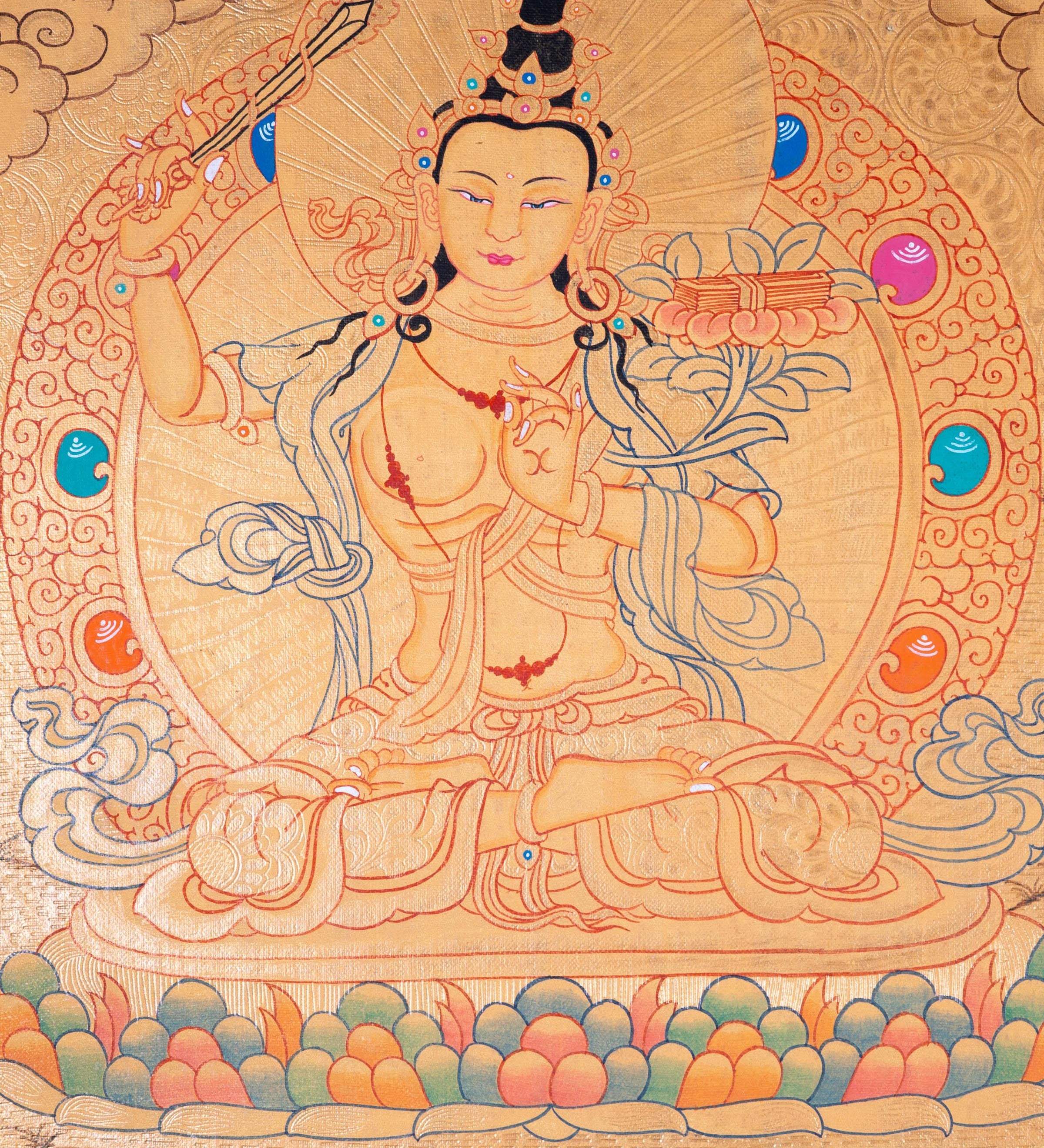 Buddhist Thangka are used as support for one's meditation practice. Manjushri is the Bodhisattva of transcendent wisdom. With the double-edged sword on his right hand he cuts through the illusion and with his left hand holds a lotus with book of Prajna Paramita.
