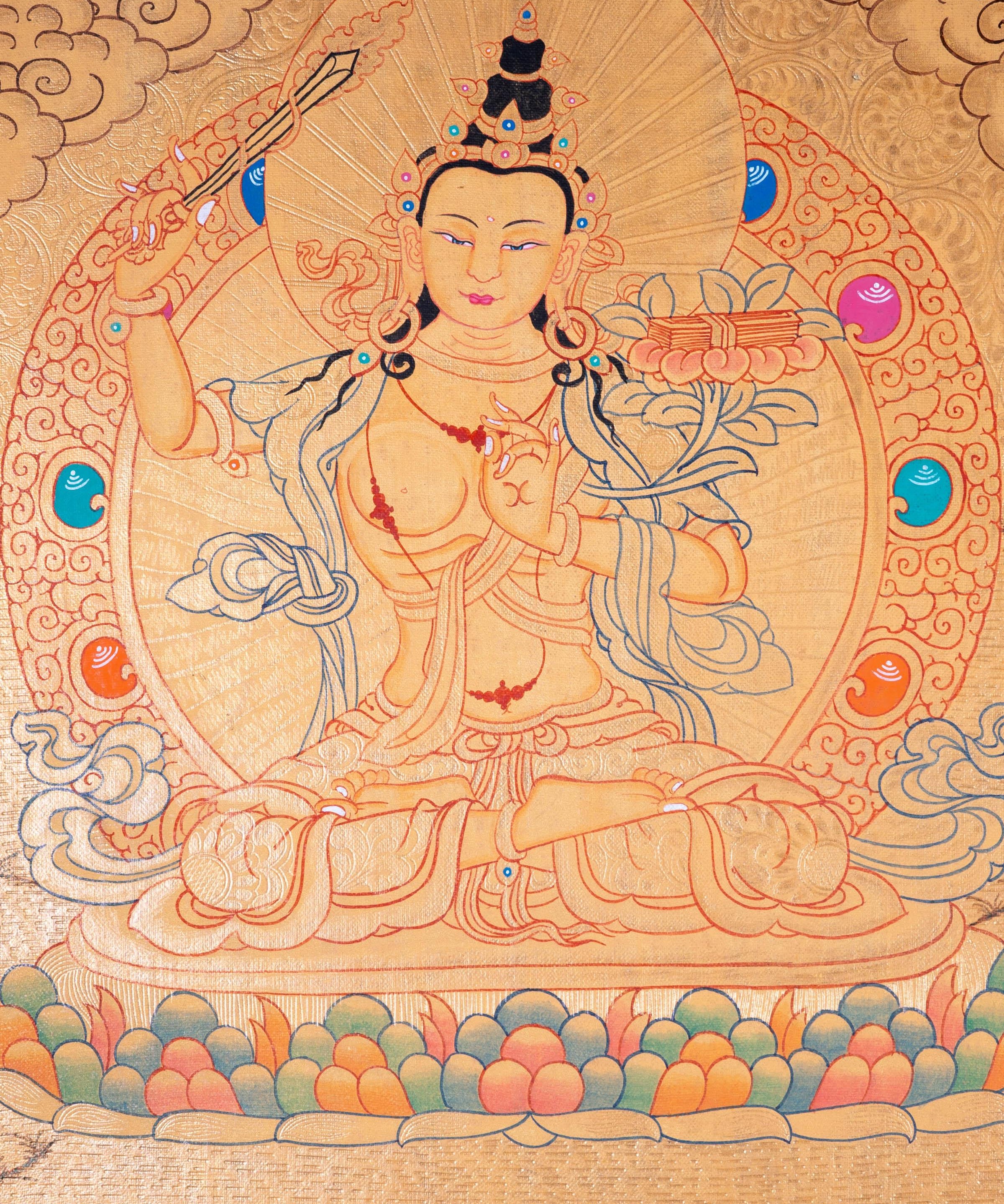 Buddhist Thangka are used as support for one's meditation practice. Manjushri is the Bodhisattva of transcendent wisdom. With the double-edged sword on his right hand he cuts through the illusion and with his left hand holds a lotus with book of Prajna Paramita.