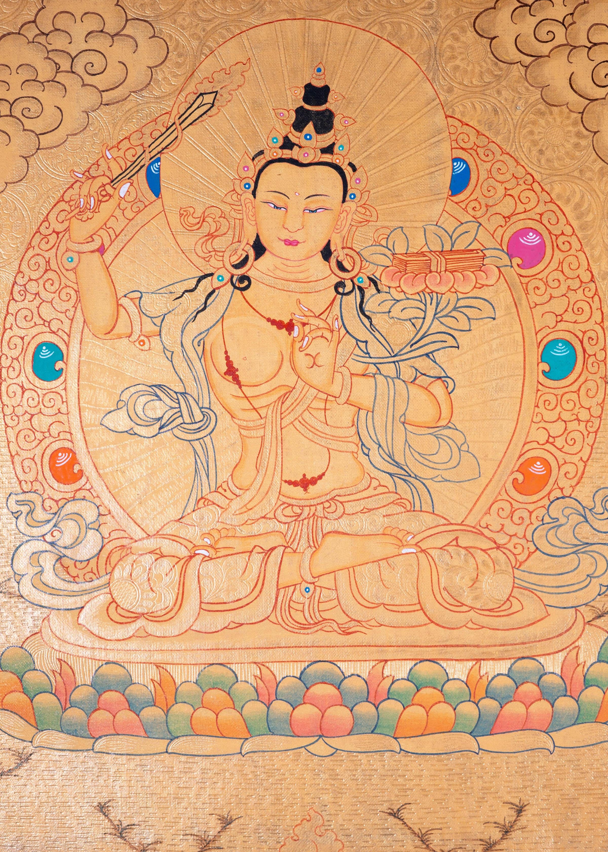 Buddhist Thangka are used as support for one's meditation practice. Manjushri is the Bodhisattva of transcendent wisdom. With the double-edged sword on his right hand he cuts through the illusion and with his left hand holds a lotus with book of Prajna Paramita.