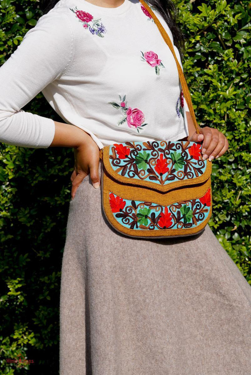 Easy to carry side bag for women, features a beautiful hand embroidered floral pattern. 