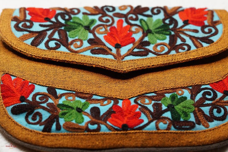 Easy to carry side bag for women, features a beautiful hand embroidered floral pattern. 