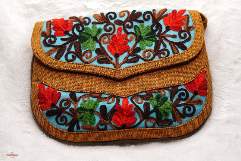 Easy to carry side bag for women, features a beautiful hand embroidered floral pattern. 