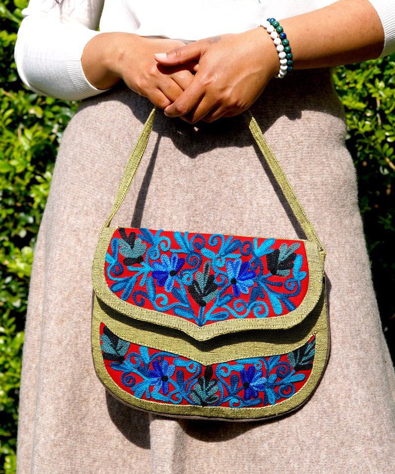 Beautiful hand embroidered crossbody bag with bright and multi-colour embroidered floral patterns.