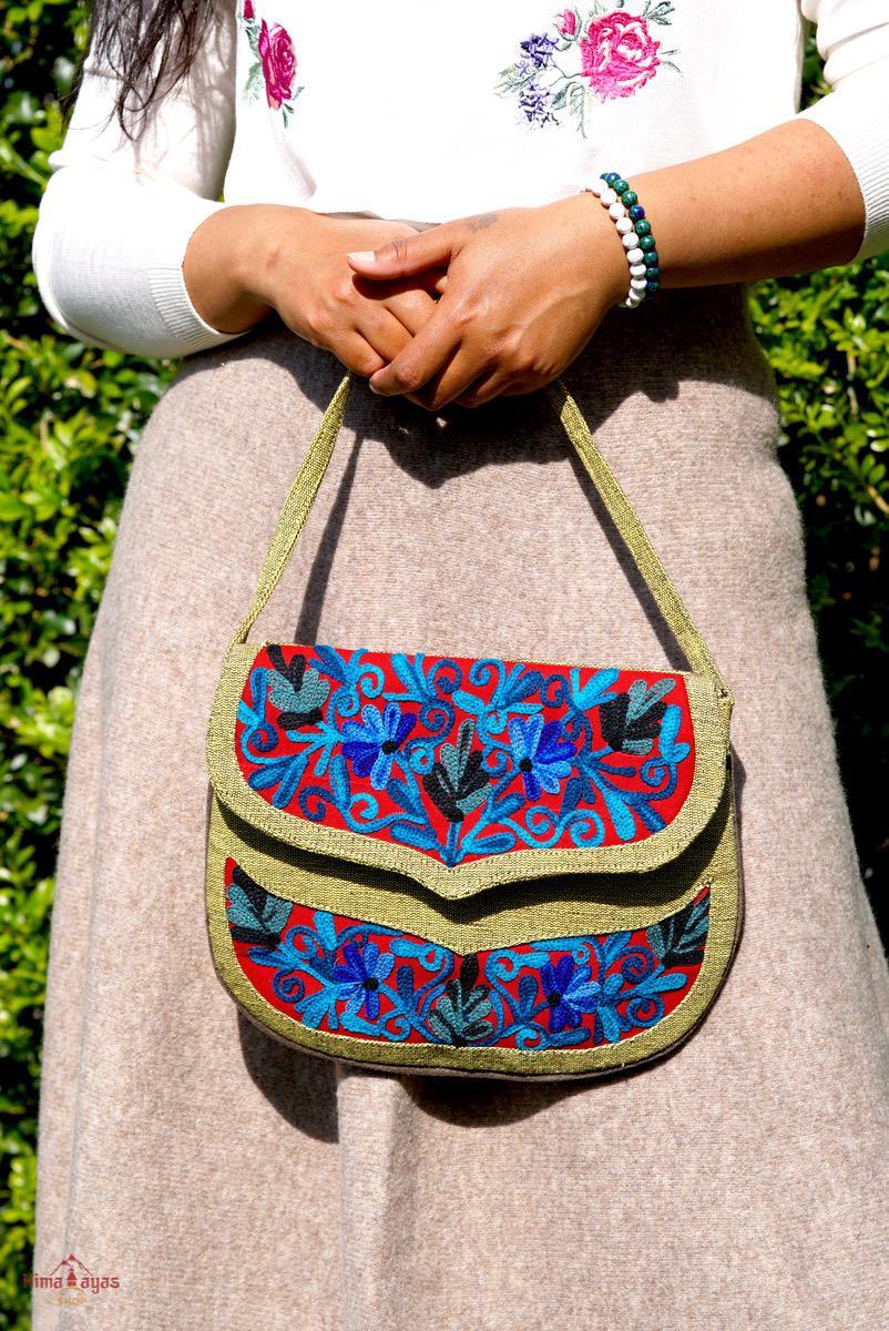 Beautiful hand embroidered crossbody bag with bright and multi-colour embroidered floral patterns.