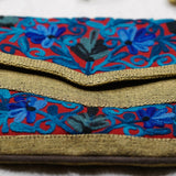 Beautiful hand embroidered crossbody bag with bright and multi-colour embroidered floral patterns.