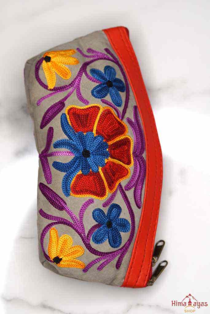 A nature inspired hand-embroidered zipper pouch, ideal as a cosmetic bag or travel essentials for everyday use.