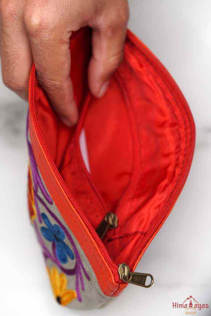 A nature inspired hand-embroidered zipper pouch, ideal as a cosmetic bag or travel essentials for everyday use.