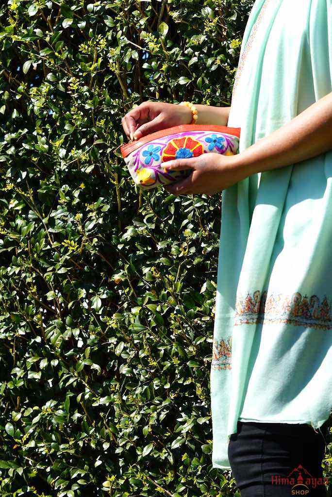 A nature inspired hand-embroidered zipper pouch, ideal as a cosmetic bag or travel essentials for everyday use.