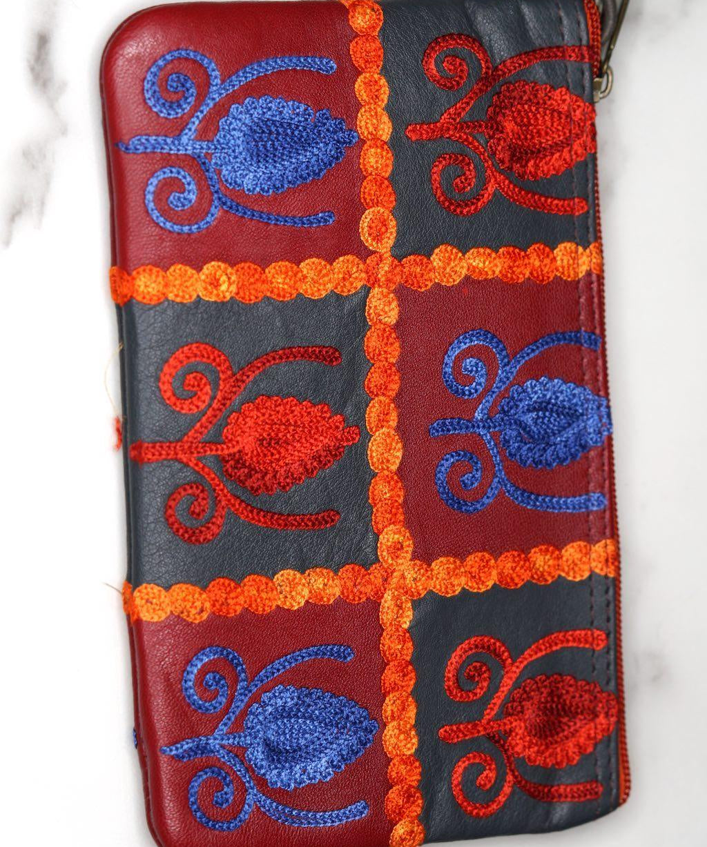 Vibrant colorful purse with kashmiri hand embroidery, has a secure zip top closure, ethically made in Nepal.