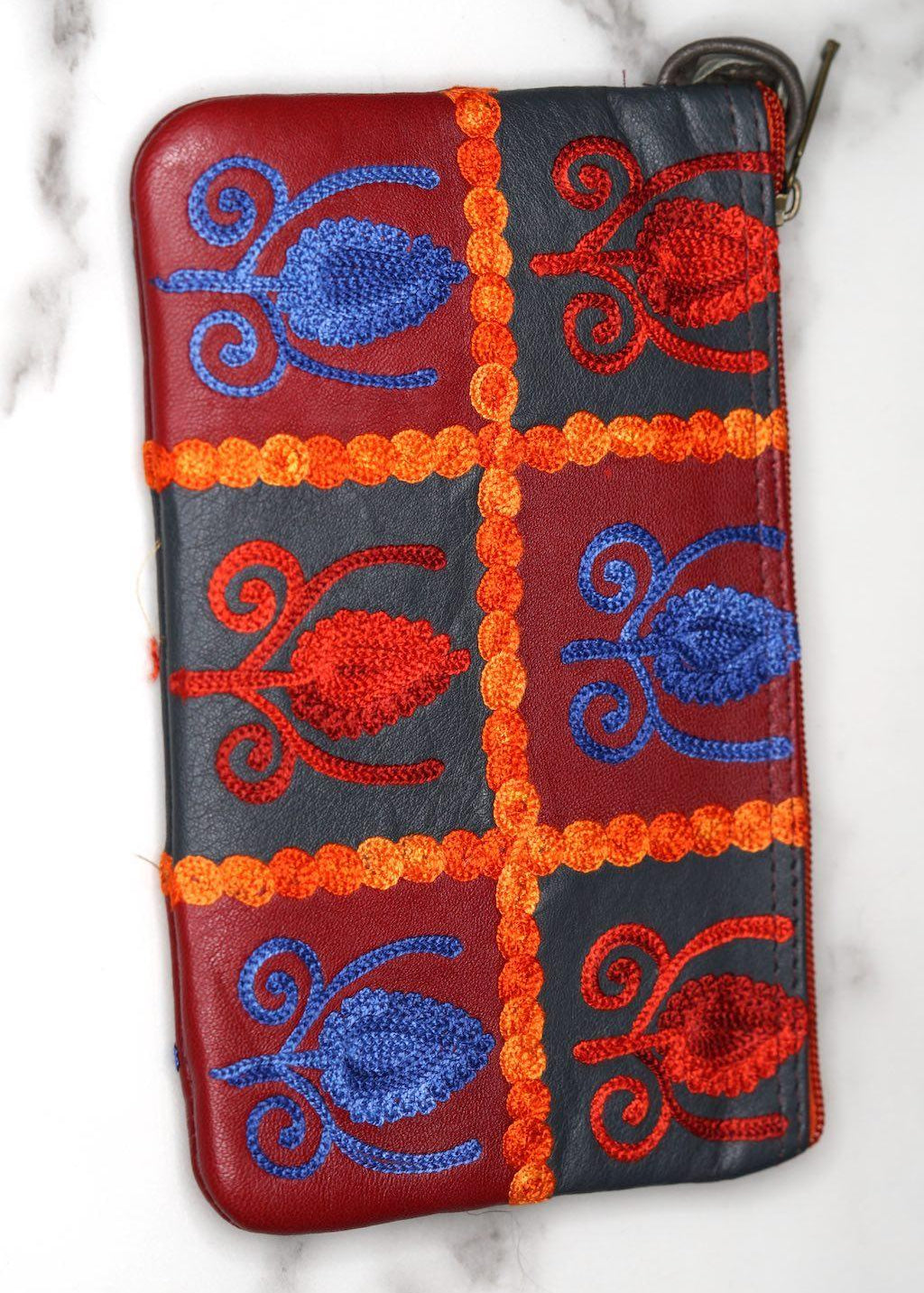 Vibrant colorful purse with kashmiri hand embroidery, has a secure zip top closure, ethically made in Nepal.
