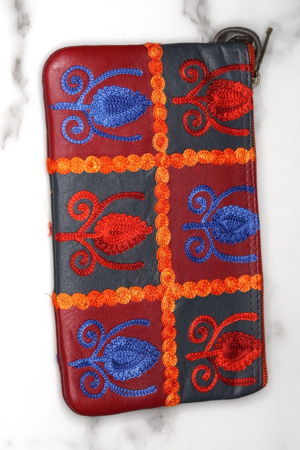 Vibrant colorful purse with kashmiri hand embroidery, has a secure zip top closure, ethically made in Nepal.