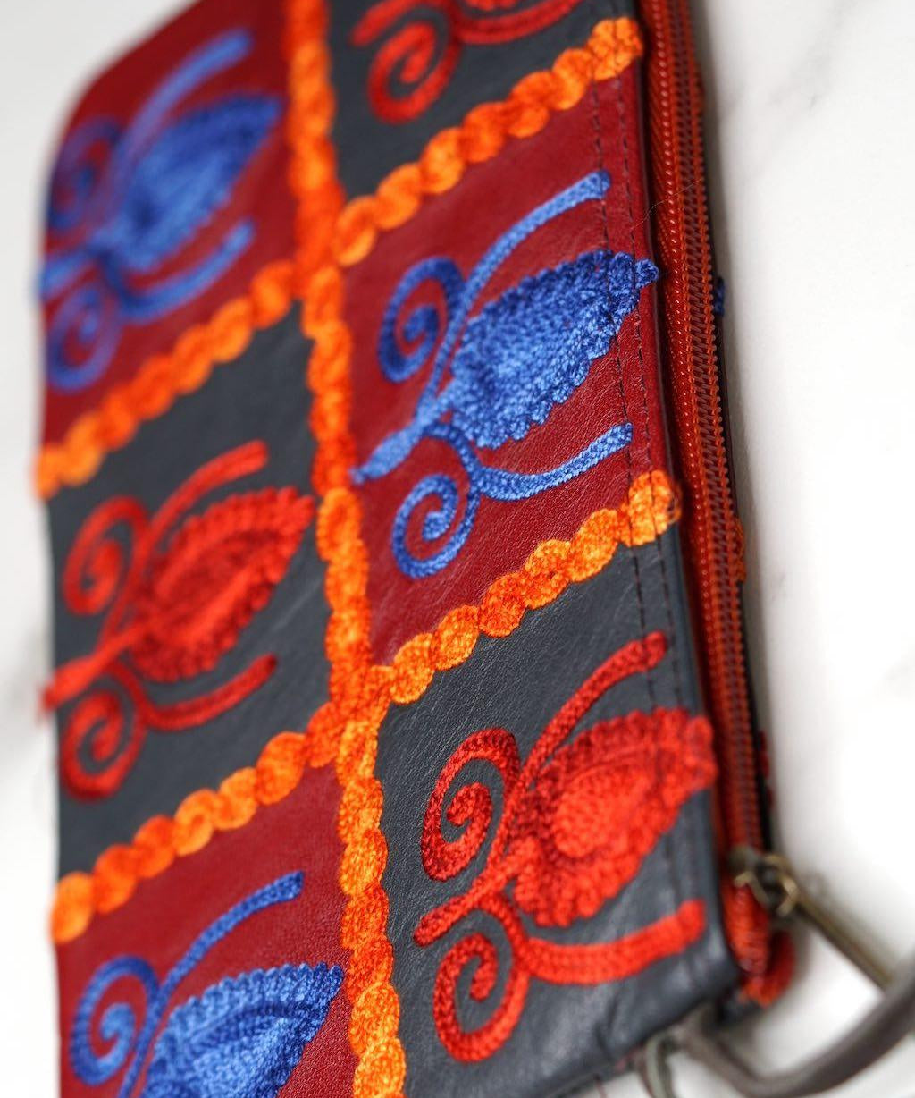 Vibrant colorful purse with kashmiri hand embroidery, has a secure zip top closure, ethically made in Nepal.