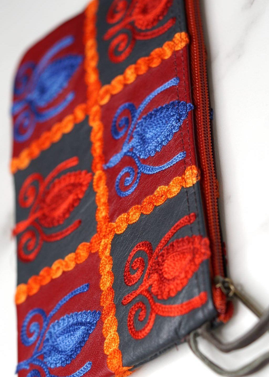 Vibrant colorful purse with kashmiri hand embroidery, has a secure zip top closure, ethically made in Nepal.