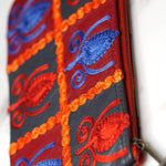 Vibrant colorful purse with kashmiri hand embroidery, has a secure zip top closure, ethically made in Nepal.