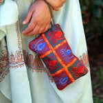 Vibrant colorful purse with kashmiri hand embroidery, has a secure zip top closure, ethically made in Nepal.