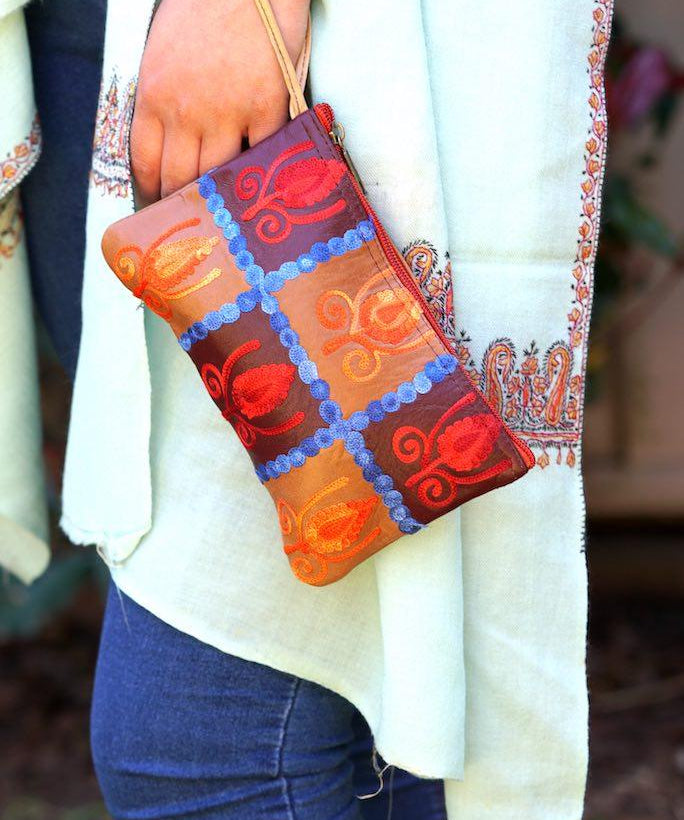 Vibrant colorful purse with kashmiri hand embroidery, has a secure zip top closure, ethically made in Nepal.