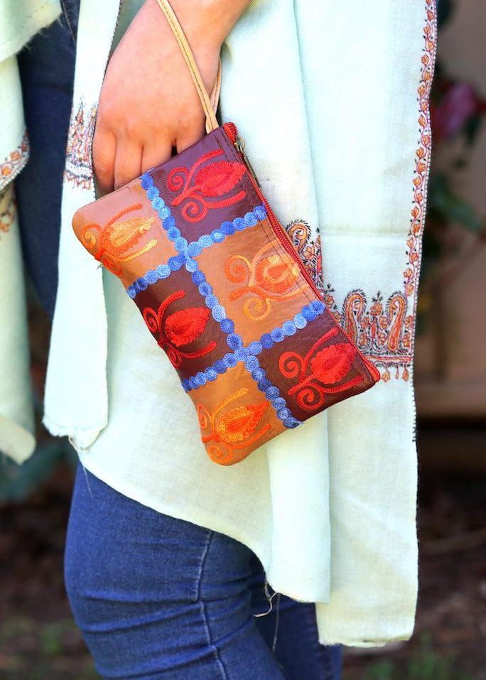 Vibrant colorful purse with kashmiri hand embroidery, has a secure zip top closure, ethically made in Nepal.